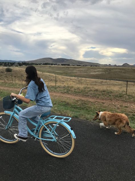 Girl riding blue bike with basket next to collie in mountains Riding Bikes Aesthetic, City Bike Aesthetic, Riding Bicycle Aesthetic, Mountain Biking Aesthetic, Collie Aesthetic, Riding Bike Aesthetic, Aesthetic Bikes, Bikes Aesthetic, Bike Riding Aesthetic