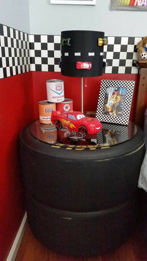 Night stand made from race car tires. Race Car Playroom, Racing Decorations House, Race Car Theme Room, Race Car Bathroom Ideas, Nascar Tire Ideas, Race Car Bedroom Decor, Cars Themed Bedroom Toddler, Nascar Bedroom Ideas, Boys Race Car Bedroom Ideas