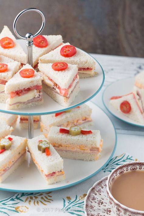 These adorable ham and pimento cheese tea sandwiches would be perfect for a Southern tea party or afternoon tea! And they're topped with the cutest pickled okra garnishes! Party Snacks For Adults, Party Sandwiches Recipes, Recept Sandwiches, Tea Party Sandwiches Recipes, Snacks For Adults, Southern Tea, Cheese Tea, Tea Party Sandwiches, Tea Sandwiches Recipes