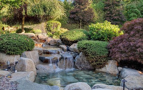 Flowing water feature river to pond in Asian garden Pond Fence, Modern Water Fountain, Indoor Backyard, Fountain For Home, Water Fountain For Home, Backyard Waterfall, Pond Landscape, Waterfall Ideas, Landscape Yard