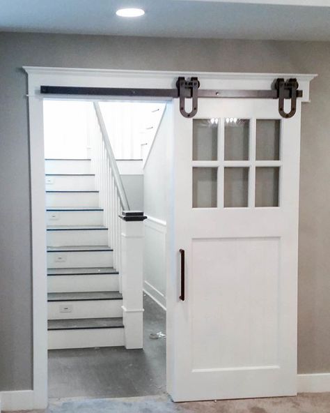 Adding the barn door at the bottom of the staircase was a great idea. It adds character and a little privacy while letting the light pour into the lower level. Just remember to open it before all stair sledding competitions. Sliding Door Diy, Basement Windows, Basement Apartment, Basement Stairs, Small Basements, Basement Walls, Basement Bedrooms, Basement Bathroom, Basement Renovations