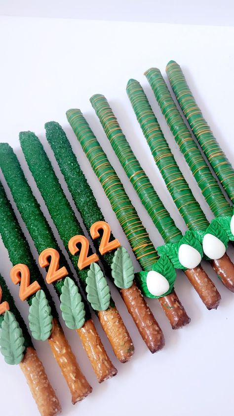 Three Rex Birthday Party Snacks, Rice Krispie Dinosaur Eggs, Jurassic Park Desserts, Dinosaur Theme Desserts, Dinosaur Chocolate Covered Pretzels, Dinosaur Snack Table, Dino Treats Birthday, Dinosaur Pretzel Rods, Dinosaur Party Desserts