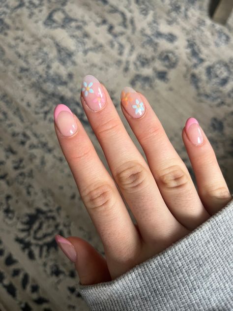 pink french tip nails with 2 blue and orange flowers Spring Time French Tip Nails, Colorful French Tip Nails With Flowers, Spring Nails 2024 Short Almond, Floral Nails French Tip, Spring Birthday Nails Almond, Spring Nail Sets Almond, Vacay Nails Short, Pink And Blue Almond Nails, Vacation Nails Flower