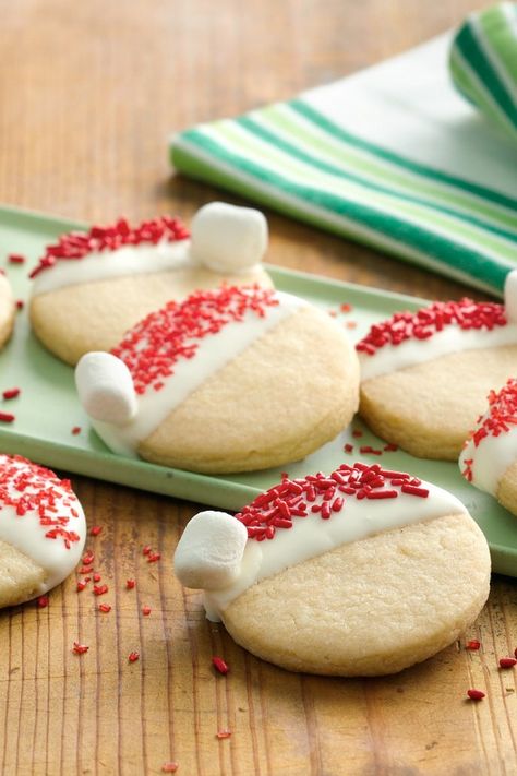 What an adorable way to get everyone in the holiday spirit! The super simple decorating instructions mean even the littlest kids can participate—Santa’s going to be extra excited when he sees these. Santa Hat Cookies, December Meals, Holiday Deserts, Winter Cakes, Decorate Cookies, Night Activities, Hat Cookies, Christmas Foods, Christmas Cookies Easy