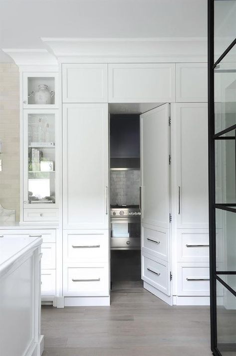 A kitchen pantry is hidden behind white wood-paneled doors that mimic floor-to-ceiling white shaker cabinets. Secret Pantry, Duplex Ideas, Fort Langley, White Wood Paneling, Kitchen Pantry Doors, Hidden Doors, Langley Bc, Hidden Pantry, Doors Ideas