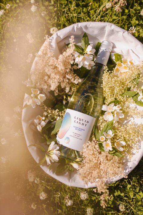 Summer wine vibes, wildflowers bring out vibrance in Sauvignon Blanc Wine Brand Photography, Summer Wine Photography, Wine Campaign Ideas, Wine Styling, Wine Product Photography, Wine Vibes, Wine And Flowers, Wine Bottle Photography, Winery Photography