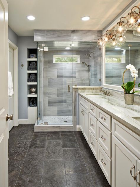 This beautiful master bathroom pulls elements from traditional and modern design styles. Recessed lighting paired with modern globe sconces -- and a small window over the shower -- ensures an always-bright space. Lena white marble, quartzite counters and limestone floors make the room feel rich and inviting. Beautiful Master Bathrooms, Master Bath Design, Limestone Flooring, Master Bath Remodel, Tile Flooring, Bathroom Layout, Traditional Bathroom, Bathroom Remodel Master, Bath Remodel