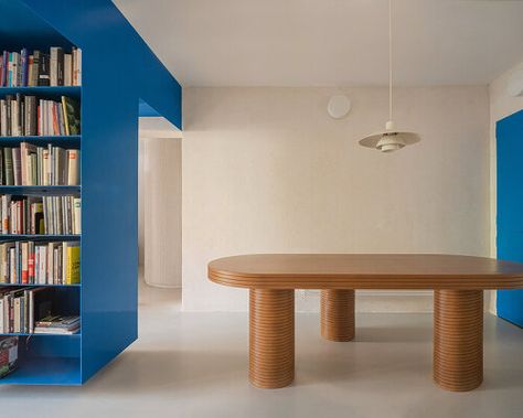 BURR turns a 1970s apartment into an experimental dwelling in madrid Yellow Headboard, Blue Bookshelves, Metal Bookcase, Load Bearing Wall, Interior Shutters, Dining And Living Room, Contemporary Apartment, Wooden Slats, The Blues