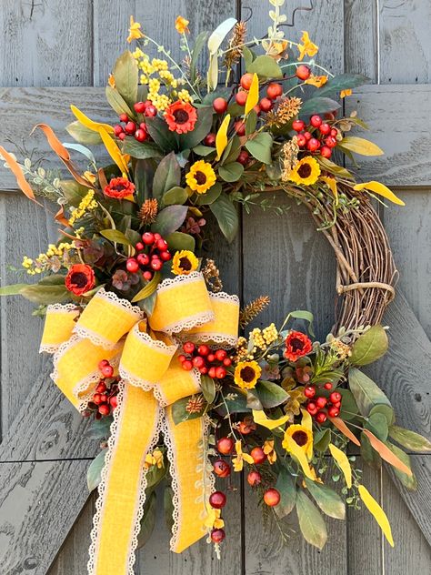 This show stopping fall wreath boasts of fall foliage comprised of gorgeous mustard yellow and rust colored flowers, orange berries, leaves and ferns. The mustard yellow bow acts as a stunning focal point and is perfect for your Thanksgiving farmhouse decor or a hostess gift for the holidays.  This autumn wreath is built on a 14 inch grapevine wreath and stretches 25 inches wide and 32 inches in height from leaf tip to leaf tip. Click here to see more fall wreaths in the shop: https://www.etsy.c Hostess Gifts Thanksgiving, Yellow Wreath, Foliage Wreath, Farmhouse Fall Decor, Sunflower Wreaths, Autumn Wreaths, Wreath Crafts, Fall Foliage, Front Door Decor