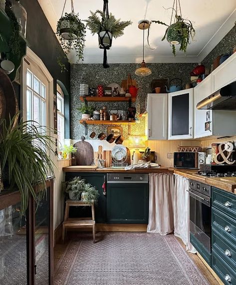 a kitchen with a chandelier and a table Boho Kitchen Table, Decorating Above Kitchen Cabinets Ideas, Above Cabinet Decor, Boho Style Kitchen, Boho Kitchen Ideas, Dark Green Kitchen, Rattan Pendant Lights, Decorating Above Kitchen Cabinets, Budget Kitchen Makeover