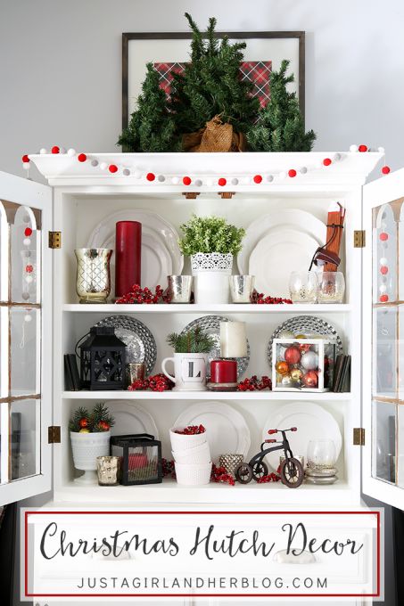 I've always wanted to style my dining room hutch for different holidays but wasn't sure how-- this post gives so many great ideas and makes it simple! My hutch is going to look beautiful for Christmas! Click through for so many awesome ideas! | JustAGirlAndHerBlog.com How To Decorate A Hutch, Christmas Hutch Decor, Christmas Hutch, Christmas Bookshelf, Hutch Decor, Dining Room Hutch, Different Holidays, Bookshelf Decor, Love Vintage