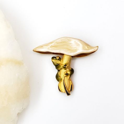 Our charming frog and mushroom brooch is even more adorable in person! This brooch is features 18K gold plating for a long-lasting finish and colorful epoxy. The size is 2 inches by 1.75 inches. #jewelryshop #etsy #statementjewelry #etsyshop #handmadejewellery #museumreproductions #etsystore #jewelrymaking #frog #brooches #brooch #cottagecore #cottagestyle #cottagecoreaesthetic #mushroom #mushrooms Mushroom Brooch, Frog And Mushroom, Cottage Core Aesthetic, Cottage Style, Statement Jewelry, Gold Plating, Etsy Store, Jewelry Shop, Brooches