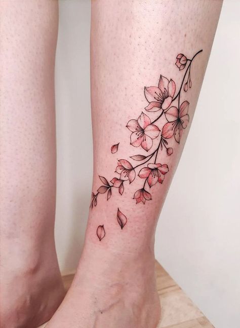 100 Elegant Cherry Blossom Tattoos (Most Unique Gallery) - The Trend Scout Cherry Blossom Wrap Tattoo, Cherry Blossom Finger Tattoo, Cherry Blossom Tattoo Leg, Cherry Blossom Tattoo On Thigh, Blossom Ankle Tattoo, Japanese Cherry Blossom Tattoo Design, Cherry Blossom Wrist Tattoo, Cherry Blossom Leg Tattoo, Cherry Blossom Sleeve Tattoo