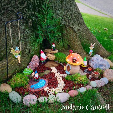 Outdoor Gnome Village Ideas, Fairy Garden Front Yard, Gnomes In Garden, Flower Bed With Tree In Middle, Fairy Garden Under Tree, Fairy Gnome Garden Ideas, Outside Fairy Garden Ideas, Knomes Garden Ideas, Garden Gnomes Ideas