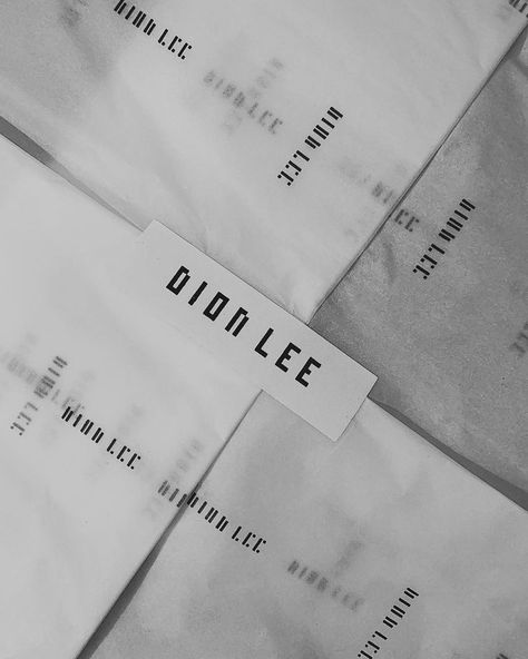 Dion Lee packaging is simplistic, with the brand logo printed in black on white stickers, bags and tissue paper. The simple packaging is visually appealing and allows for the products to stand out. Additionally, the high quality packaging adds a sense of luxury, making the customer feel special and exclusive. Logo For Bags Brand, Fashion Layout, Simple Packaging, Dion Lee, Paper Packaging, White Stickers, Feel Special, Brand Packaging, Tissue Paper