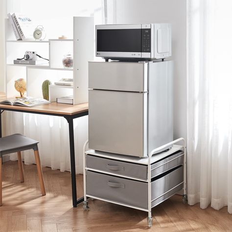 PRICES MAY VARY. Durable Steel Frame in White designed to hold your compact mini-fridge (up to 110lbs) 2 Light Gray Fabric Drawers with Pull Handle to hold cooking supplies, snacks, cups, plates, etc No tools required for assembly - Includes 4 caster wheels (2 with locking mechanisms) for easy movement Keeps your compact fridge off the ground to easily reach items, while providing additional storage for smart use of your space Overall Dimensions: 23.2"W x 22"D x 21.3"H Space in your apartment or College Dorm Furniture, Dorm Kitchen Essentials, Fridge Stand, Mini Fridge Stand, Dorm Kitchen, Compact Fridge, Grey Drawers, Dorm Furniture, Twin Xl Bedding