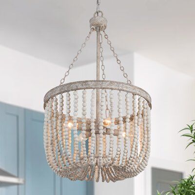 Fresh Air and open frame 4-light ambient lanterns chandelier harmonize weathered hand-painted wooden beads, and distressed gray finish together to form a lovely drum-shaped openwork shade that naturally drops down. This unique/statement pendant lamp ingeniously captures the stunning point with charming vintage shadows when you turn on the light. Prepare 4 E12 type B bulbs to create the best lighting visual sense. With a bohemian trend in mind, this fixture will create a calming vibe for a stairw Draped Chandelier, Boho Light Fixture, Wooden Bead Chandelier, Wood Bead Chandelier, Metal Light Fixture, Classic Chandelier, Lantern Chandelier, Chandelier Modern, Farmhouse Chandelier