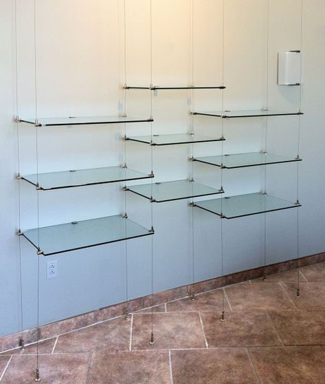 Glass shelves are suspended on 13 foot long cables Suspended Shelves, Wine Glass Shelf, Glass Shelves In Bathroom, Glass Shelves Decor, Glass Shelves Kitchen, Floating Glass Shelves, Glass Wall Shelves, Verre Design, Regal Design