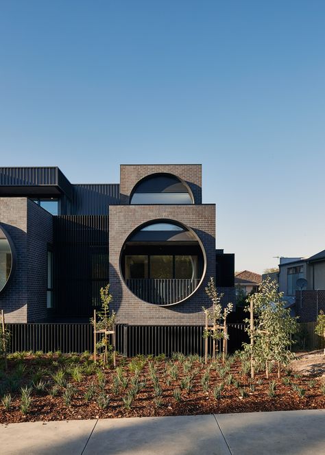 Circular windows dominate the staggered brick facades of this apartment block designed by Australian practice BKK Architects for Melbourne's Ivanhoe East. Circular Windows, Melbourne Apartment, Modern Residential Architecture, Porthole Window, Modern Architecture Design, Brick Facade, Facade Architecture, Roof Design, Futuristic Architecture