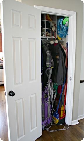 messy coat closet/ link to "after"  Drapery tie backs used as hooks for scarves, storing the vacuum cleaner!  Closet/mud room Coat And Vacuum Closet, Coat Closet With Vacuum Storage, Dyson In Closet, Container Store Coat Closet, Vacuum Closet Organization, Where To Store Vacuum Cleaner, Store Vacuum Cleaner, Vacuum Storage Ideas, Vacuum Closet