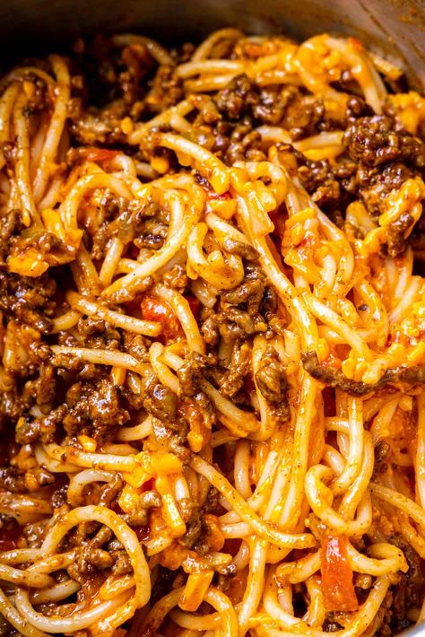 Taco Spaghetti gives a family favorite a fun taco night twist! Spaghetti in cheesy beefy taco meat sauce made with taco seasoning and salsa. Chili And Spaghetti Recipe, Hamburger Meat Recipes Taco, Tacos With A Twist, Saucy Taco Meat Recipes, Spaghetti With A Twist, Crockpot Taco Spaghetti, Spaghetti Tacos Recipe, Taco Speggetti Recipes, What To Do With Leftover Taco Meat