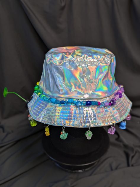 -hat color - silver -bead color - rainbow -charm color - rainbow -unisex adult size -inner circumference - 22.5in -crown dip - 3in -brim - 2.25in -NOT machine washable -Perfect for raves and outdoor festivals! Shipping within the US USPS First Class Package 3-9 days USPS Priority Mail 1-5 days USPS Priority Mail Express 1-3 days Shipping International  USPS First Class Mail International  -Varies- USPS Priority Mail International 6-14 days USPS Priority Mail Express International 3-9 days Shipping times are estimated, NOT GUARENTEED.  +International buyers are responsible for all import fees+ +Orders of $50+ may require signature confirmation upon delivery+ Rave Bucket Hat, Rainbow Festival, Rainbow Ombre, Color Rainbow, Rave Festival, Festival Vibes, Silver Bead, Bucket Hats, Rave Outfits