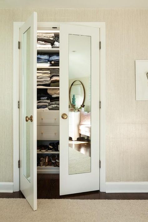 Bi-fold mirrored closet doors with brass knobs in a transitional walk-in girls bedroom closet featuring tan raffia wallpaper. Mirrored Closet Doors, Small Closet Door Ideas, Mirrored Closet, Transitional Bedroom Design, Closet Mirror, Bedroom Closet Doors, Mirror Closet Doors, Chic Dining Room, Bifold Closet Doors