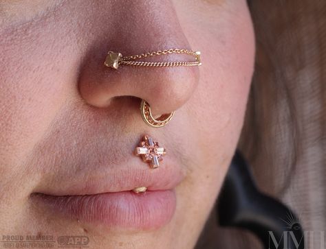 Last year Taryn pierced Karissa’s vertical philtrum and recently installed this stunning custom piece with Orange and Champagne Sapphires! ✨ #mmhtaryn #mmhkarissa #verticalphiltrumpiercing #makemeholey #makemeholeybodypiercing #appmember #safepiercing #sanjosepiercing #sanjosepiercer #bayareapiercers #bvla @bvla @quetzallijewelry @hialeahfinejewelry @piercingsbytaryn Vertical Philtrum, Stretched Philtrum Piercing, Septum And Vertical Labret, Medusa Piercing Jewelry Philtrum, Inverse Vertical Labret, Medusa Piercing Jewelry Opal, Philtrum Piercing, Piercings, Champagne