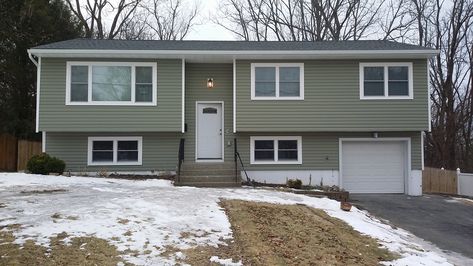 Raised ranch with green siding and white trim. Green Split Level Exterior, Raised Ranch Remodel Exterior, Raised Ranch Exterior, Green Vinyl Siding, Split Level Exterior, Raised Ranch Remodel, Split Level House Plans, Green House Exterior, Green Siding