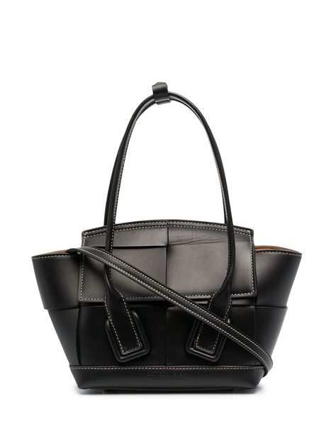 Black leather mini Arco tote bag from BOTTEGA VENETA featuring signature Maxi Intrecciato design, contrast stitching, two top handles, adjustable detachable shoulder strap, front flap closure, main compartment and internal zip-fastening pocket. Bag Wishlist, Celine Luggage Bag, Givency Antigona Bag, Shopper Tote, Black Tote Bag, Leather Mini, Bottega Veneta, Persona, Top Handle Bag