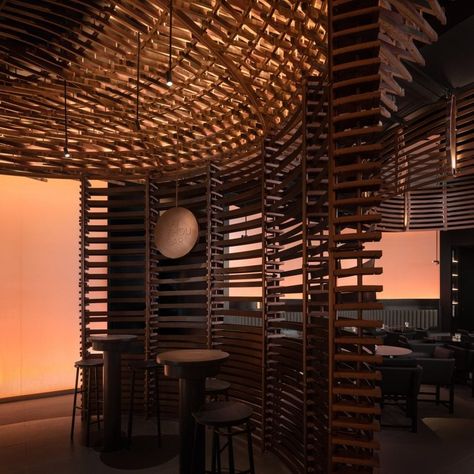 The bar's slatted partition walls are made from barrel offcuts. Ceiling Domes, Dome Structure, Chinese Interior, Whiskey Barrels, Bar Ceilings, Whiskey Bar, White Building, Wine Display, Wooden Barrel