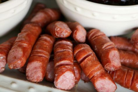 A Halloween appetizer featuring lil' smokies cut to look like fingers that are placed on a white serving dish. Halloween Dip, Halloween Finger, Halloween Appetizer, Halloween Finger Foods, Lil Smokies, Scary Food, Halloween Party Appetizers, Halloween Party Food, Cranberry Cream Cheese