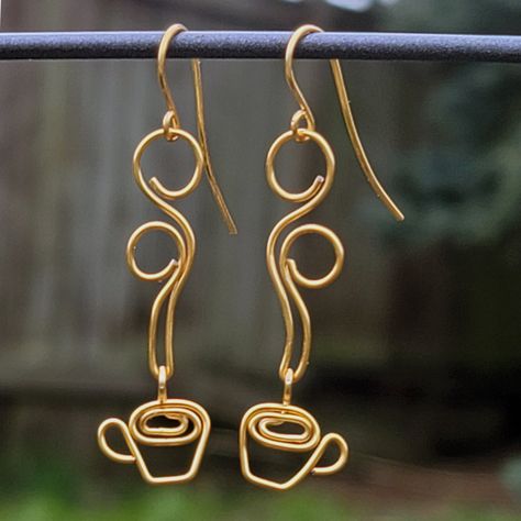 These beautiful, handcrafted coffee earrings are wire wrapped out of high quality non-tarnish coated copper wire and are perfect for coffee lovers! WIRE COLORS: Gold, Silver, Rose Gold, Vintage Bronze and Antique Copper. EAR WIRES: While the main earring design is made from a copper core wire (explained below), the ear wires are made out of 100% hypoallergenic Niobium -- making them safe to wear for those with sensitive ears. DESIGN WIRE: The wire has a copper core, with a high quality non-tarnish coating. So, you have the benefits of wearing copper, without the greening that affects raw copper. IMPORTANT: All jewelry is handmade to order, so they may not look exactly like the picture. CARE: Store out of direct sunlight and keep away from water. SHIPPING: Rings are shipped inside a cotton Coffee Earrings, Diy Wire Jewelry Rings, Coffee Earring, Wire Jewelry Earrings, Wire Jewelry Rings, Wire Wrapped Jewelry Diy, Wire Jewelry Designs, Diy Wire Jewelry, Wire Work Jewelry