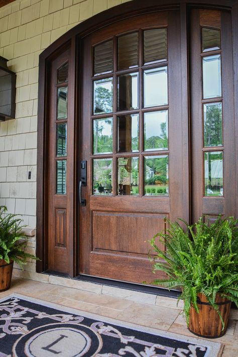 Our Trinity Collection is a homeowner favorite with two-panel and three-panel options, as well as multiple iron designs and window formations. With many takes on this traditional design, the Trinity Collection will transform your home with its archtop and sidelights. Experience the DSA Doors difference: premium wood doors master-crafted in Raleigh, NC Front Entry Doors With Sidelights And Transom, Glass Single Door, Entrance Wood Door, Replacing Front Door, Entry Door With Sidelights, Cottage Front Doors, Unique Front Doors, Glass Door Design, Beautiful Front Doors