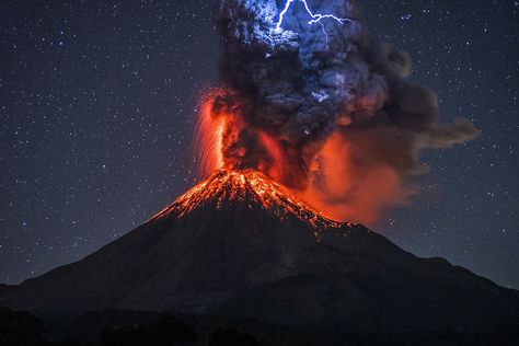 These incredible images capture the moment a lightning bolt struck an erupting volcano.  A graphic designer camped out in freezing cold conditions to snap a shot of an erupting volcano – only for a volcanic lightning bolt to strike the lava spurt and make the image even better. Erupting Volcano, Natural Phenomena, Nature Photographs, Alam Yang Indah, Science And Nature, Amazing Nature, Volcano, Nature Pictures, Natural Wonders