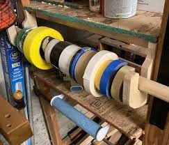 Tape Storage - FineWoodworking Tape Storage Garage, Tape Storage Ideas, How To Store Tape Rolls, Workshop Tape Organizer, Wood Tape Dispenser, Tape Organizer, Closet Bar, Tape Storage, Wooden Closet