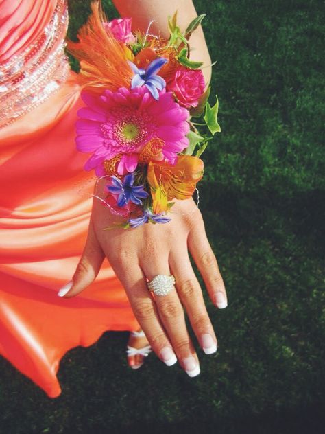 2023 Corsage Trends, Purple And Orange Corsage, Bright Wrist Corsage, Bright Orange Corsage, 2023 Prom Flower Trends, Wildflower Corsage Prom, Colorful Corsage Wedding, Fuschia Corsage And Boutonniere, Colorful Prom Corsage