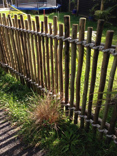 Casual fence made from smooth but irregular sticks, bound with rope Fence Made From Branches, Fence Made Of Sticks, Fence Out Of Sticks, Tree Branch Fence, Stick Fences, Creative Fence Ideas, Natural Fencing, Stick Fence, Unique Fence Ideas