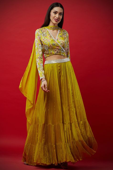 Featuring a lemon yellow overlap blouse in tussar silk base with floral print and zardosi embroidery. It is paired with a matching gathered lehenga and dupatta in crepe silk base.  FIT: Fitted at bust and waist. COMPOSITION: Crepe silk, Tussar silk. CARE: Dry clean only. Blouse Lehenga, Yellow Floral Blouse, Yellow Lehenga, Embroidered Lehenga, Unique Blouse Designs, Lehenga Blouse, Unique Blouse, Wedding Lehenga, Silk Lehenga