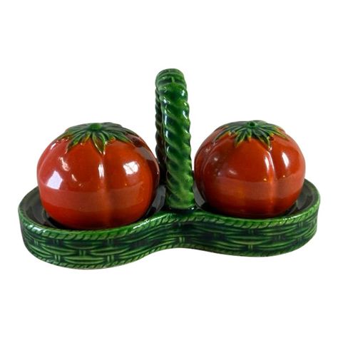 Hovde Park Home invites you to bring a whimsical touch to your dining table with this delightful three-piece set featuring salt and pepper shakers and a coordinating carrying tray. Crafted from ceramic, the set is designed to resemble two bright red tomatoes nestled in a charming green basket.  The ceramic basket-shaped tray, finished in a vibrant green glaze, stands at 2.625 inches tall, 4.625 inches long, and 2.25 inches deep. It features two round spaces perfectly sized to cradle the tomato-shaped salt and pepper shakers. The shakers, each measuring 1.375 inches tall and 1.625 inches across, mimic the appearance of small tomatoes complete with green leaves and stems.  This playful set not only serves a practical purpose but also adds a touch of whimsy and color to your dining experience Salt And Pepper Shaker Display, Novelty Salt And Pepper Shakers, Ceramic Salt And Pepper Shakers, Salt And Pepper Clay Shakers, Salt And Pepper Ceramic Shakers, Salt And Pepper Shakers Ceramic, Salt And Pepper Shakers Pottery, Green Basket, Kitchenware Set