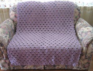 The Lavender Lace Throw is perfect for any crocheter looking to keep things easy. Using the crochet shell stitch and V stitch, this pattern creates a lovely lace motif. Lacy Afghan Crochet Pattern Free, Lavender Chair Crochet Patterns, Lavender Blanket Crochet, Lacy Diamond Crochet Blanket, Lacy Crochet Baby Blanket Free Pattern Shells, Afghan Crochet Patterns Easy, Crochet Afgans, Crochet Afghan Patterns Free, Crochet Shell Stitch