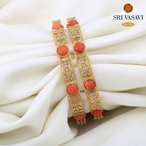 A stunning Pair of Bangles in coral topped by a pretty clasp. Wear this mesmerizing pair of 22kt gold bangles studded with coral stones and watch everyone go speechless with admiration. Coral Bangles, Bangles Design, Bangles Jewelry Designs, Gold Bangles Design, Coral Stone, Coral Jewelry, Bangle Designs, Classic Jewelry, Buy Gold