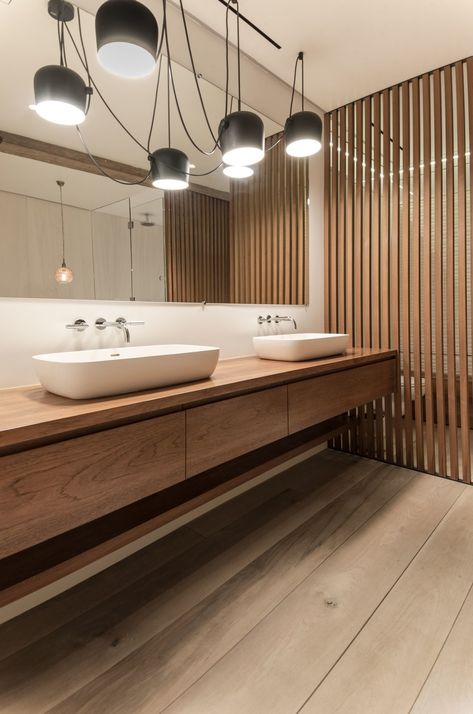 Bath Room, Light Hardwood Floor, Wood Counter, Vessel Sink, and Pendant Lighting In the master bathroom, the teak vanity and wood screens were designed by Isaac-Rae and custom built by a furniture maker. The sinks by Apaiser were also made custom. The lighting is by Flos. Teak Bathroom, Teak Vanity, Floor Wood, Light Hardwood, Light Hardwood Floors, Wood Screens, Bathroom Pendant Lighting, Attic Renovation, Bathroom Design Decor