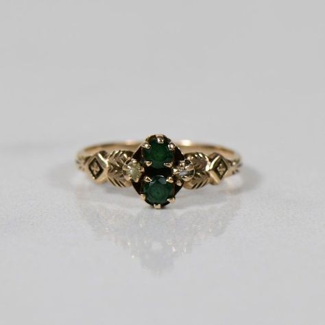 This Victorian-inspired ring is crafted from warm yellow and rose gold.  Two green glass stones reminiscent of era-inspired gemstones are complemented by delicate seed pearls. The ring embodies vintage elegance with ornate details. Size: 5.25.   Metal: 10K Yellow/Rose Gold (tested). Weight: 1.6g.   Width: 7.87mm.  Finger to Top: 3.54mm.   R-1023CSP-N525 Dreamy Accessories, Agate Wedding Ring, Victorian Engagement Rings, Victorian Ring, Vintage Green Glass, Warm Yellow, Victorian Rings, Dream Engagement Rings, Ring Ideas