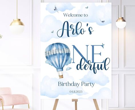 Personalised Blue ONEderful Hot Air Balloon birthday party welcome sign.  Matching invitations, buntings, stickers, party box stickers and banners available. Digital format - This will be emailed to you in PDF format. Please note no physical item will be received. Printed version - These are printed onto high quality thick card stock and are available in A4, A3 or A2. Please note - A2 signs do not stand alone on an easel due to their size and will require a foam board or to be placed in a frame. Please provide the following information when placing your order: Name Date Email address if purchasing a Digital copy. Please don't hesitate to get in touch with any questions you may have or to check progress of an order. Please note: The easel is for demonstration purposes only. POSTAGE: All pri Hot Air Balloon Birthday Party, Hot Air Balloon Birthday, Air Balloon Birthday, Balloon Birthday Party, Party Welcome Sign, Pastel Party, Milestone Poster, Welcome Poster, First Birthday Invitations