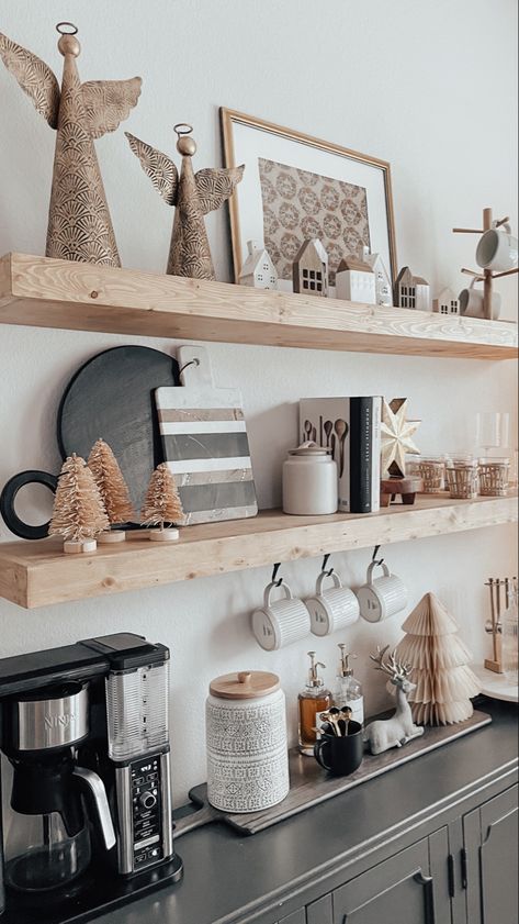 Kitchen floating shelves decorated for Christmas with antique brass angles, bottle brush trees, framed wrapping paper, cutting boards, holiday houses Christmas Decor Kitchen Shelves, Kitchen Open Shelf Christmas Decor, Kitchen Shelves Christmas Decor, Floaying Shelf Christmas, Nordic Kitchen Decor, Christmas Wall Shelves Kitchen, Barrel Texture, Holiday Coffee Bar, Kitchen Decor Collections