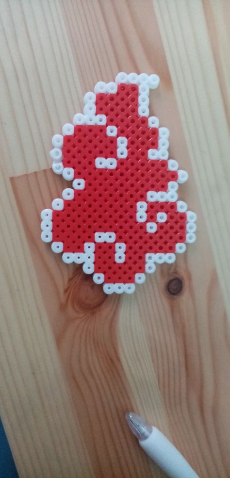 I made the Akatsuki symbol with perler beads! Isn't it gorgeous?! Akatsuki Perler Beads, Perler Bead Patterns Naruto, Naruto Perler Beads Pattern, Anime Pearler Beads Patterns, Chainsaw Man Perler Bead, Perler Bead Anime, Hama Pearls Ideas, Naruto Perler Beads, Anime Perler Beads