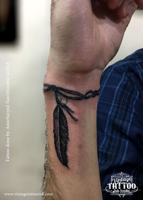 Small Fill In Tattoos For Sleeve Men, Feather On Wrist Tattoo, Wrist Tattoos Men Band, Mens Wrist Band Tattoos, Mens Feather Tattoo Forearm, Forearm Man Tattoo, Tattoo Ideas For Men Arrow, Rope Around Wrist Tattoo, Men Feather Tattoo Ideas