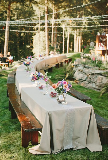 Long Banquet Wedding Tables: Spring Flowers and Ribbon  | Brides.com Casual Wedding Reception Seating, Picnic Table Decor Wedding, Picnic Bench Wedding Tables, Decorated Picnic Tables, Casual Seating Wedding, Wedding Banquet Tables, Casual Backyard Wedding Reception, Picnic Style Wedding, Casual Backyard Wedding