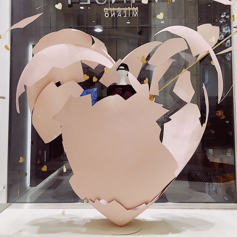 Love struck. Our window display for the opening of the new #twinset store in Milan. The heart is made of a fiberglass shell cut up to emulate the lines of a cracked egg #joanntanstudio #setdesign #visualmerchandising Valentines Window Display, Spring Window Display, Store Front Windows, Visual Merchandiser, Love Struck, Behind The Glass, Cracked Egg, Creative Display, Merchandising Displays